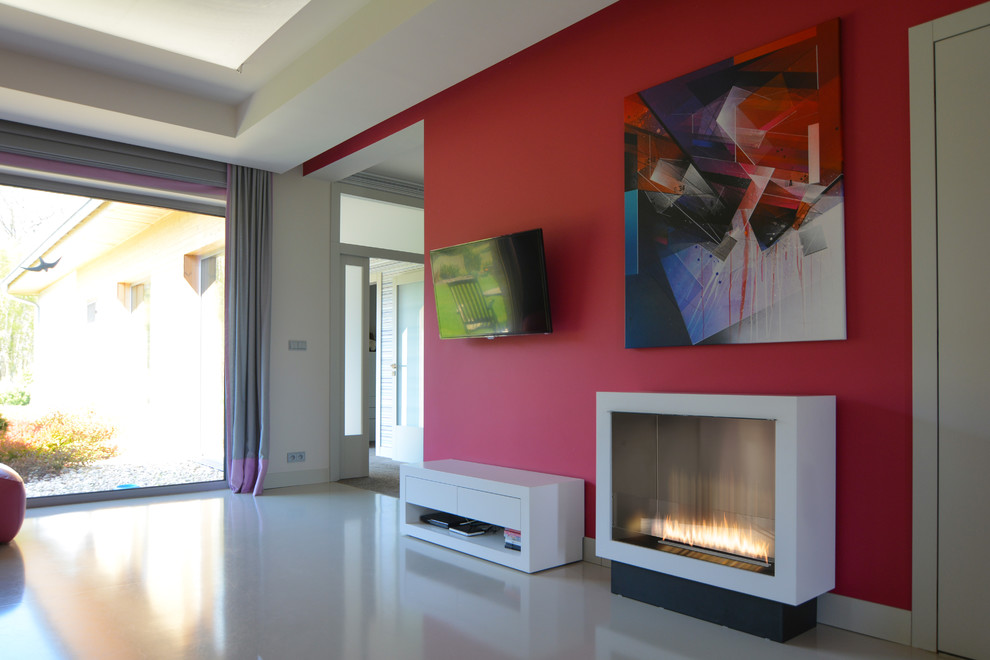 Large contemporary open concept family room in Richmond with red walls, concrete floors, a ribbon fireplace and a wall-mounted tv.