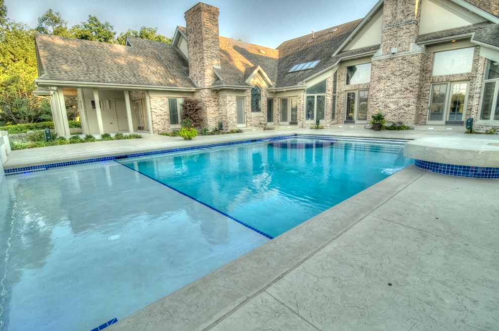 Hot tub - large transitional backyard concrete paver and rectangular natural hot tub idea in Cedar Rapids