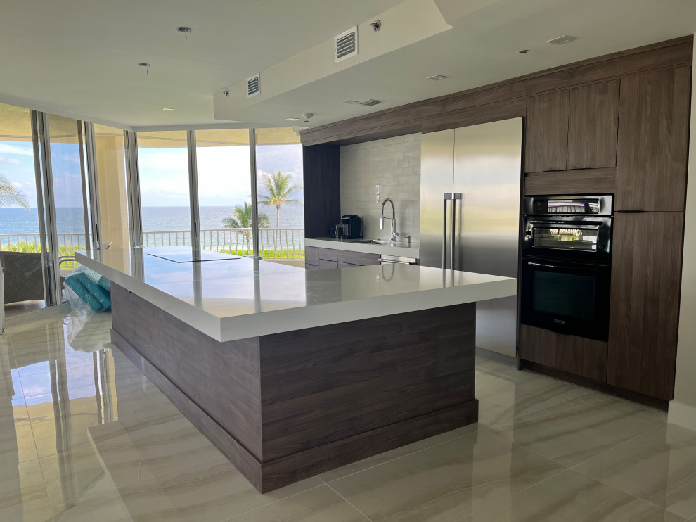 Mid-sized minimalist single-wall eat-in kitchen photo in Other with an integrated sink, flat-panel cabinets, medium tone wood cabinets, quartz countertops, white backsplash, subway tile backsplash, stainless steel appliances, an island and white countertops