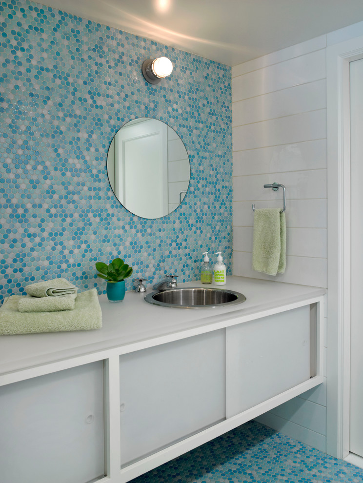 This is an example of a contemporary bathroom in New York with an undermount sink and blue floor.