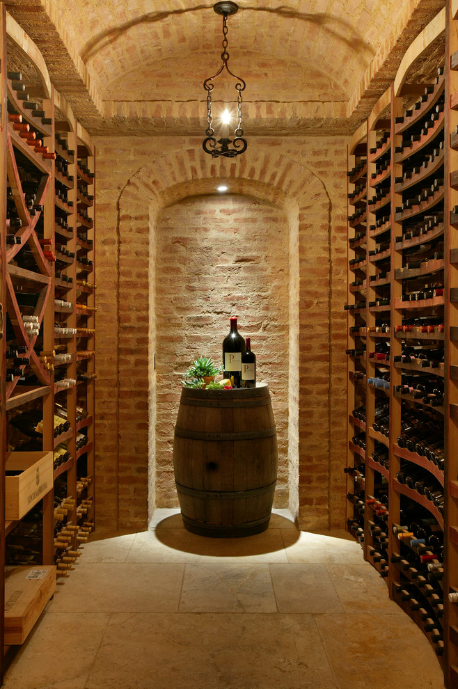 Inspiration for a mediterranean wine cellar in New York with storage racks and beige floor.