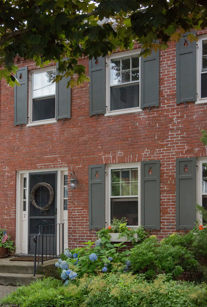 Mid-sized traditional red two-story brick exterior home idea in Boston