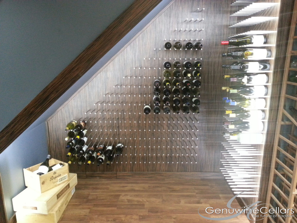 Photo of a small modern wine cellar in New York with medium hardwood floors and storage racks.