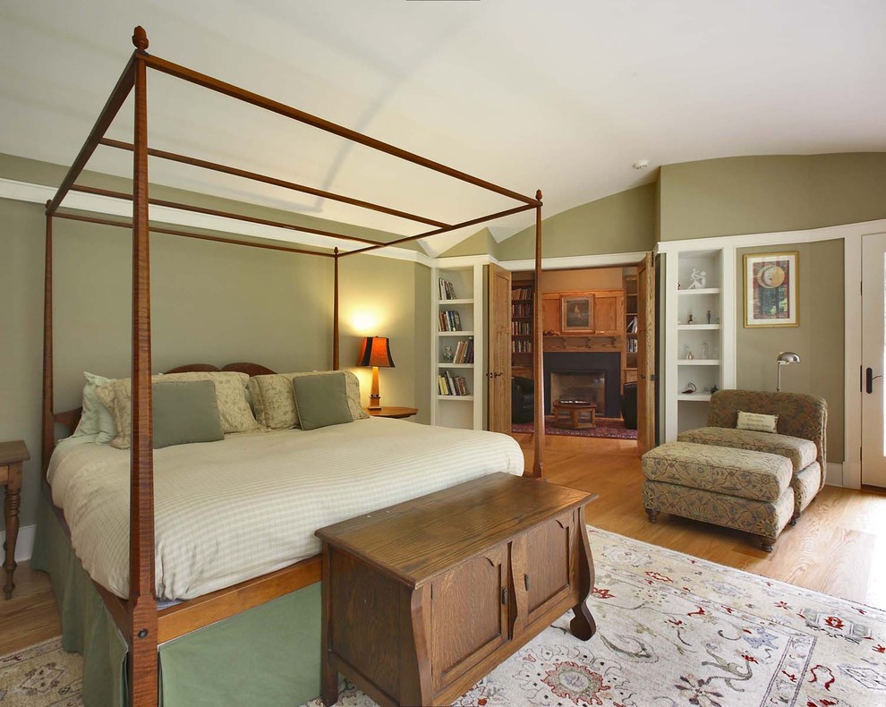 Inspiration for a traditional bedroom in New York with green walls and medium hardwood floors.
