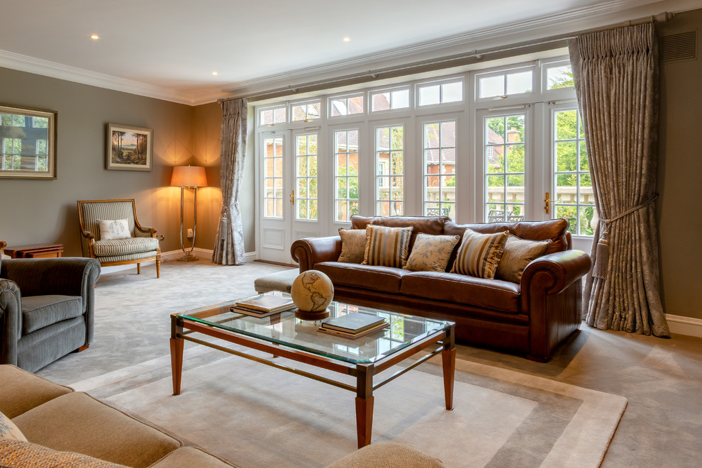 This is an example of a large eclectic living room in Dublin with carpet, a standard fireplace, a stone fireplace surround, a freestanding tv and grey floor.