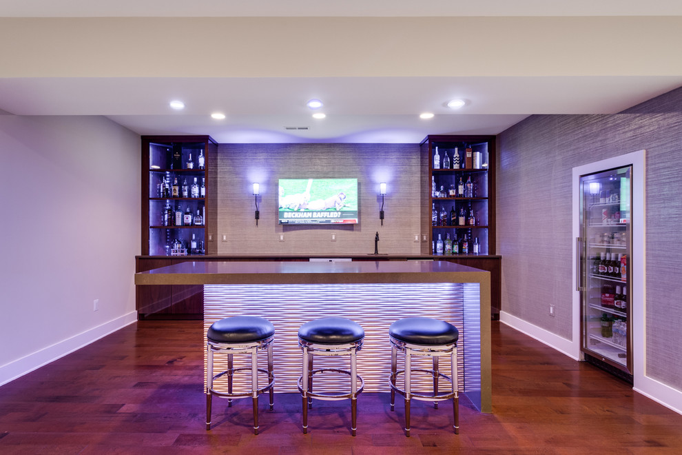 Photo of a transitional single-wall wet bar in DC Metro with an undermount sink, flat-panel cabinets, dark wood cabinets, quartz benchtops, brown splashback, dark hardwood floors, brown floor and brown benchtop.