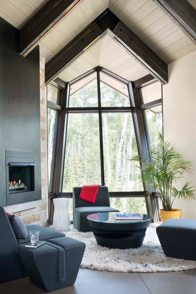 Inspiration for a contemporary living room in Denver with white walls, concrete floors and a corner fireplace.