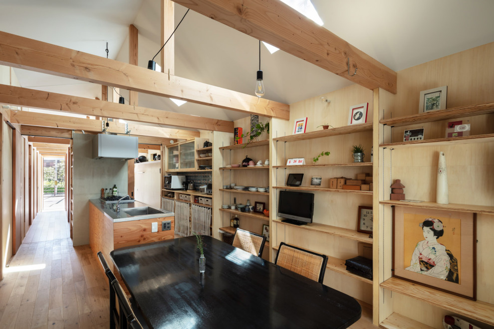 Small industrial kitchen/dining combo in Osaka with brown walls, plywood floors, no fireplace, brown floor, recessed and wood walls.