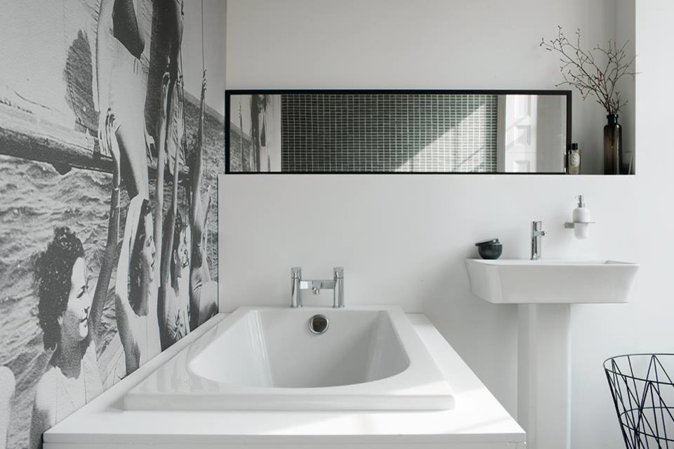Mid-sized contemporary kids bathroom in Cambridgeshire with flat-panel cabinets, white cabinets, a drop-in tub, a curbless shower, a one-piece toilet, gray tile, porcelain tile, grey walls, marble floors and a pedestal sink.