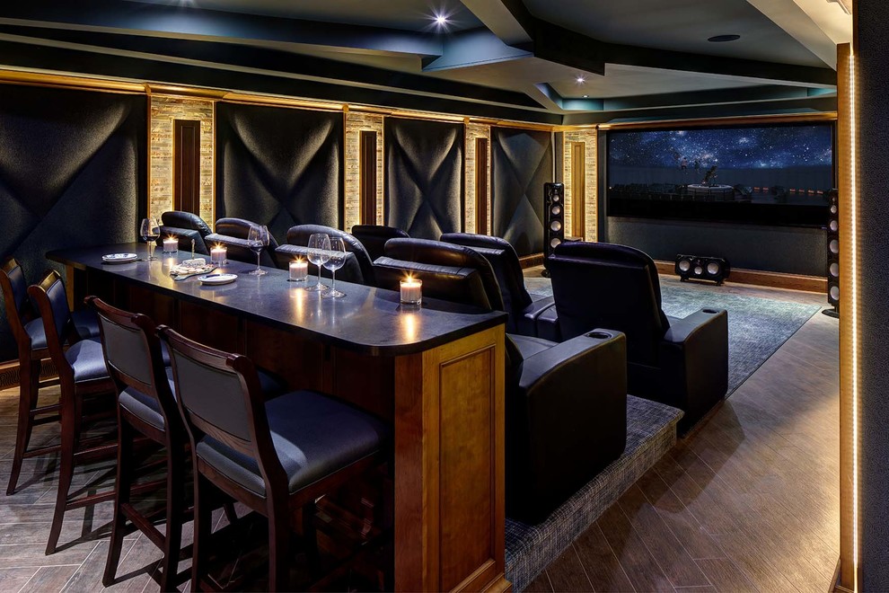 This is an example of a large transitional open concept home theatre in New York with blue walls, porcelain floors, a projector screen and brown floor.