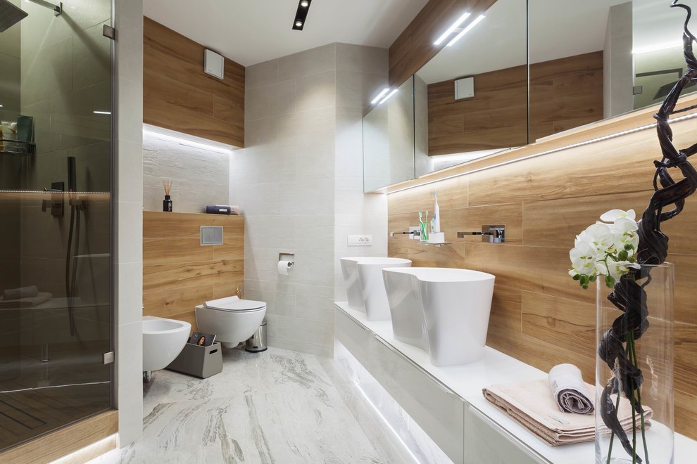 This is an example of a contemporary bathroom in Other with flat-panel cabinets, white cabinets, a wall-mount toilet, a vessel sink, white floor, an alcove shower and a hinged shower door.
