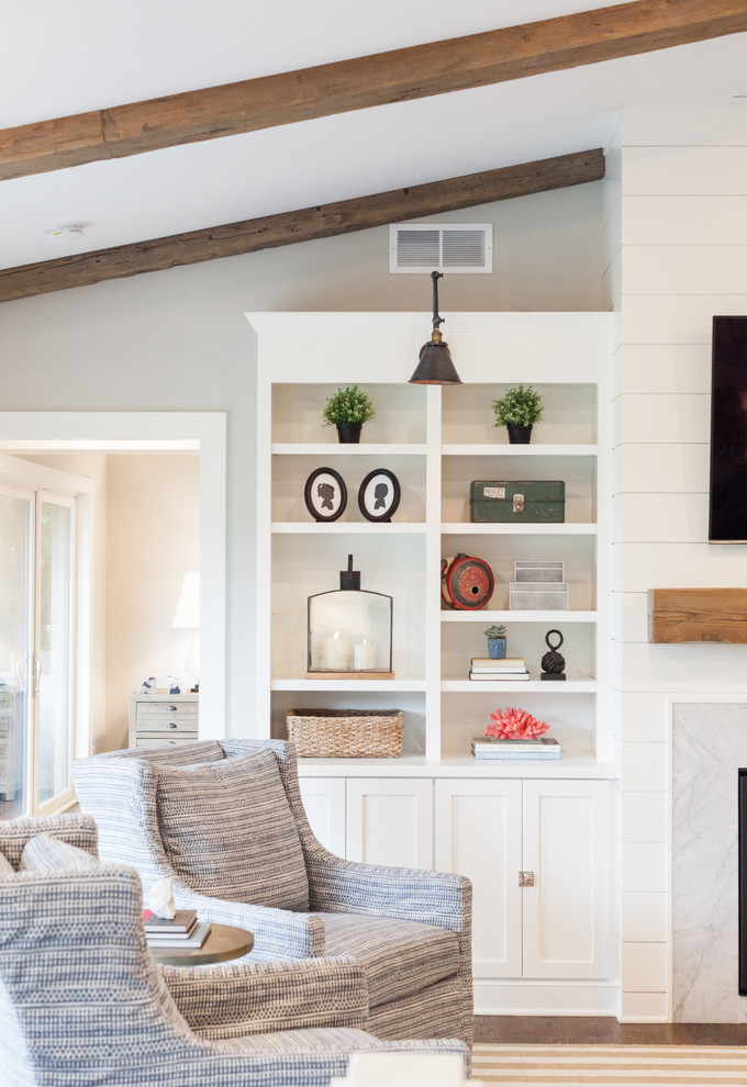 Photo of a large beach style open concept family room in Minneapolis with grey walls, dark hardwood floors, a standard fireplace, a stone fireplace surround and a wall-mounted tv.