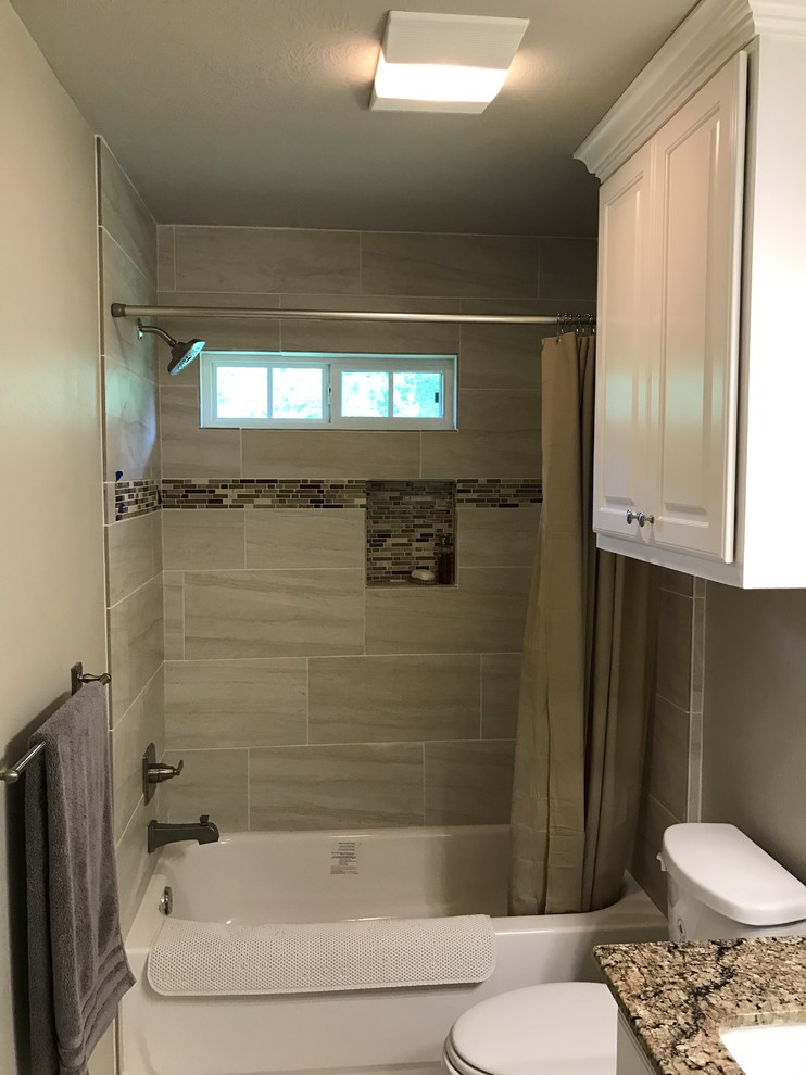 Small traditional 3/4 bathroom in Austin with raised-panel cabinets, white cabinets, an alcove tub, a shower/bathtub combo, a two-piece toilet, beige tile, porcelain tile, beige walls, porcelain floors, an undermount sink and granite benchtops.