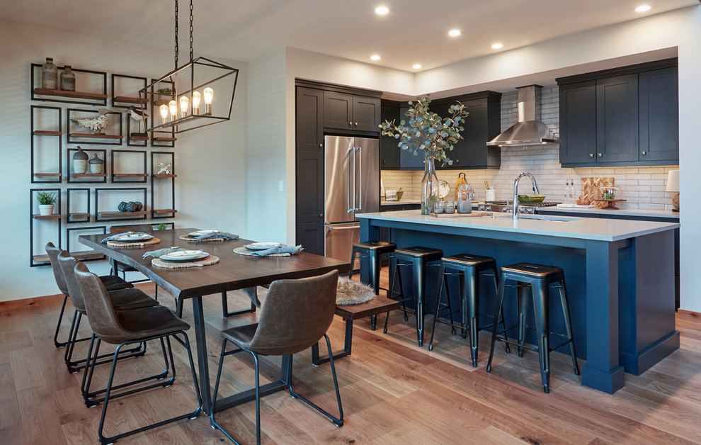 Inspiration for a rustic medium tone wood floor and brown floor kitchen/dining room combo remodel in Calgary with white walls