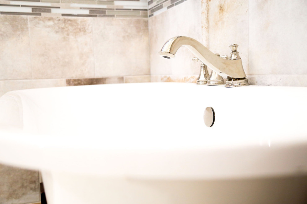 Example of a mid-sized transitional master black and white tile, gray tile and matchstick tile light wood floor claw-foot bathtub design with raised-panel cabinets, dark wood cabinets, multicolored walls, a vessel sink and granite countertops