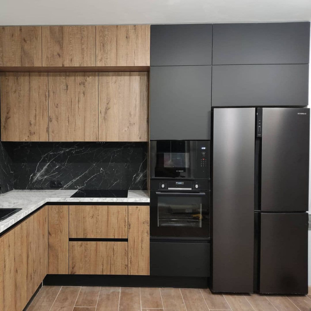 Photo of a mid-sized contemporary l-shaped eat-in kitchen in Moscow with a drop-in sink, flat-panel cabinets, black cabinets, solid surface benchtops, black splashback, porcelain splashback, black appliances, medium hardwood floors, no island, brown floor and grey benchtop.