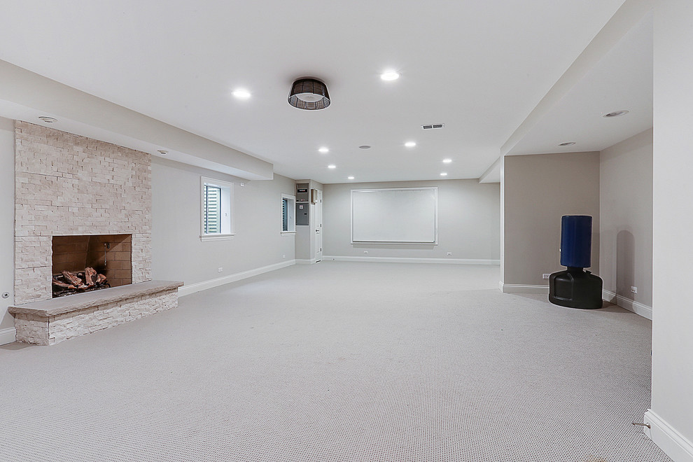 Inspiration for a large transitional fully buried basement in Chicago with beige walls, carpet, a standard fireplace, a tile fireplace surround and beige floor.
