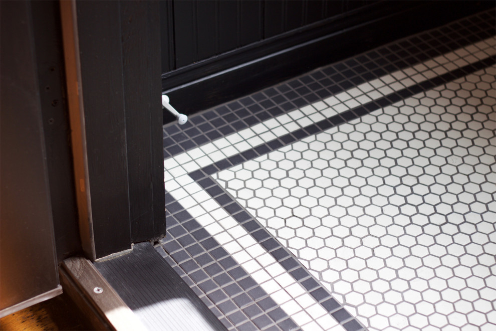 Design ideas for a small traditional vestibule in Other with black walls, ceramic floors and panelled walls.