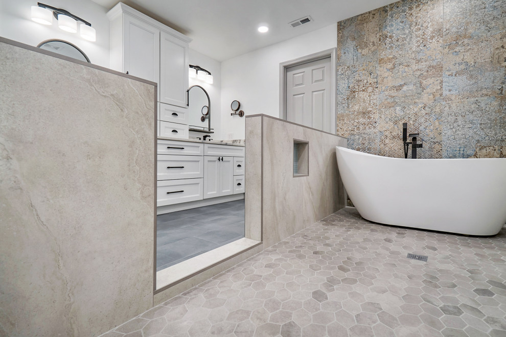 Modern inredning av ett stort grå grått en-suite badrum, med luckor med infälld panel, vita skåp, ett fristående badkar, en öppen dusch, en toalettstol med hel cisternkåpa, flerfärgad kakel, klinkergolv i keramik, ett nedsänkt handfat, granitbänkskiva, grått golv och med dusch som är öppen