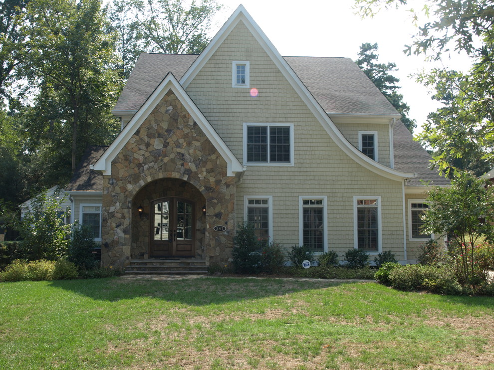 Design ideas for a large arts and crafts two-storey brown exterior in Charlotte with stone veneer.