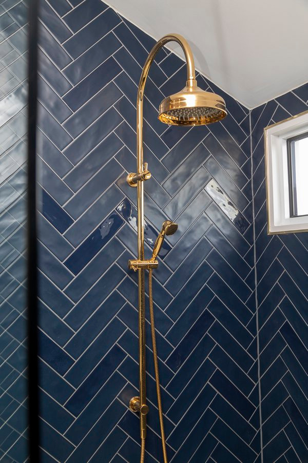 Inspiration for a large traditional master bathroom in Melbourne with shaker cabinets, blue cabinets, a curbless shower, a wall-mount toilet, blue tile, porcelain tile, blue walls, ceramic floors, a wall-mount sink, marble benchtops, multi-coloured floor, an open shower, multi-coloured benchtops, a single vanity and a freestanding vanity.
