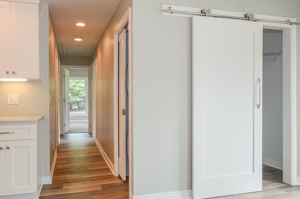 This is an example of a small transitional hallway in Cleveland with grey walls.