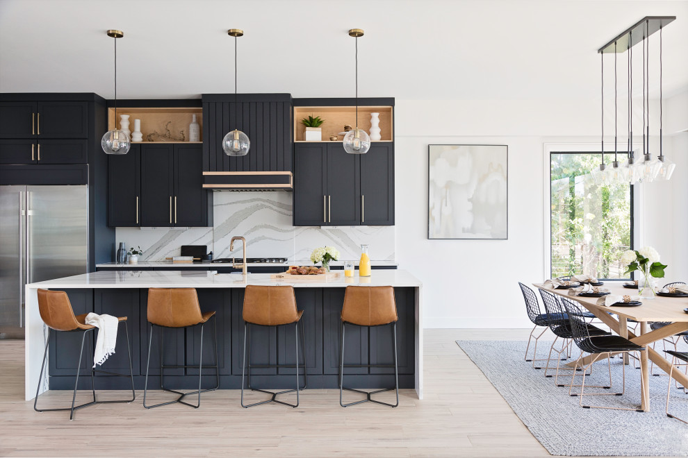 Inspiration for a large transitional l-shaped beige floor eat-in kitchen remodel in Tampa with a farmhouse sink, shaker cabinets, black cabinets, multicolored backsplash, porcelain backsplash, stainless steel appliances, an island and white countertops