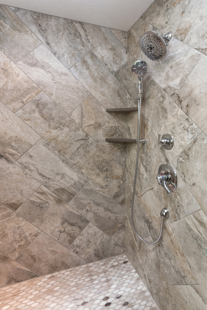 Inspiration for a transitional master gray tile freestanding bathtub remodel with a vessel sink, white cabinets, quartz countertops, a two-piece toilet and gray walls