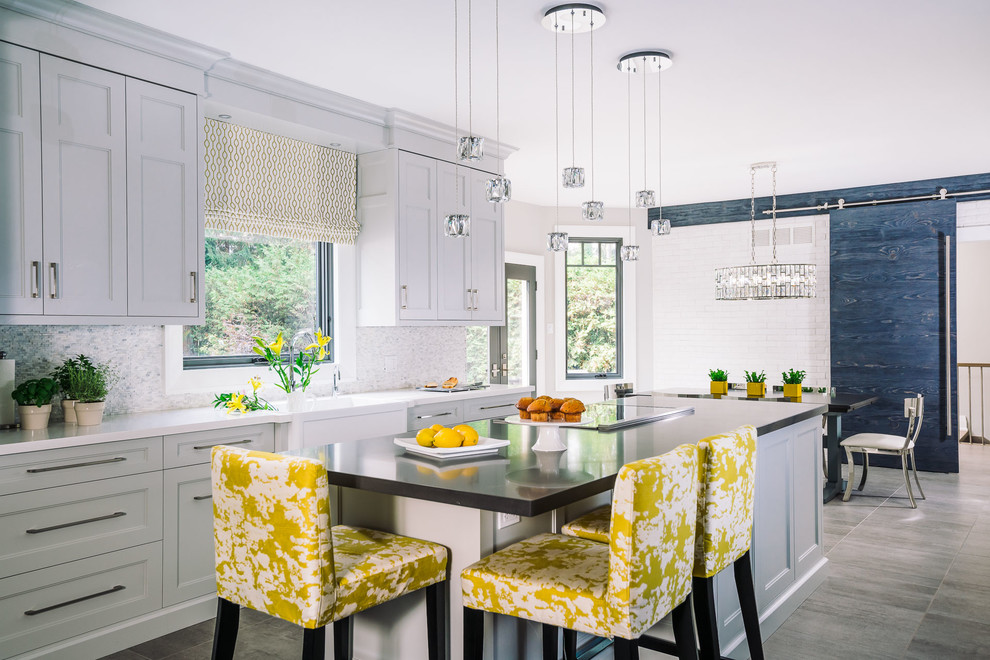 Transitional gray floor eat-in kitchen photo with a farmhouse sink, shaker cabinets, gray cabinets, multicolored backsplash, mosaic tile backsplash and an island