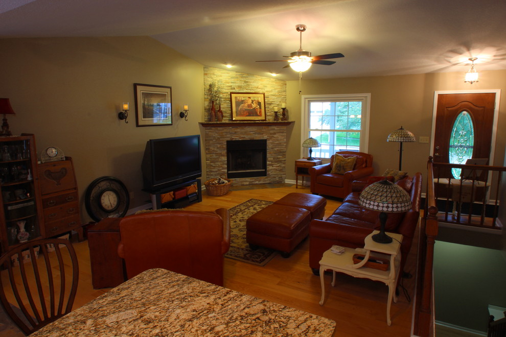 Mid-sized elegant formal and open concept light wood floor home design photo with beige walls, a standard fireplace, a stone fireplace and a tv stand