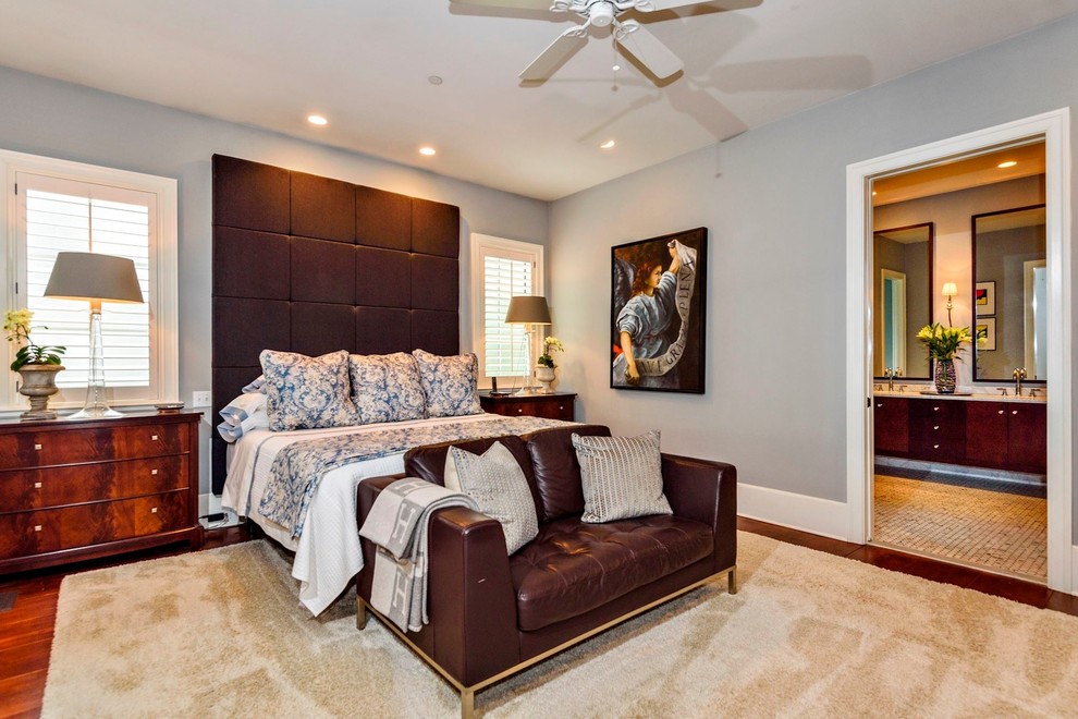 Inspiration for a mid-sized mediterranean master bedroom in DC Metro with grey walls, medium hardwood floors and brown floor.