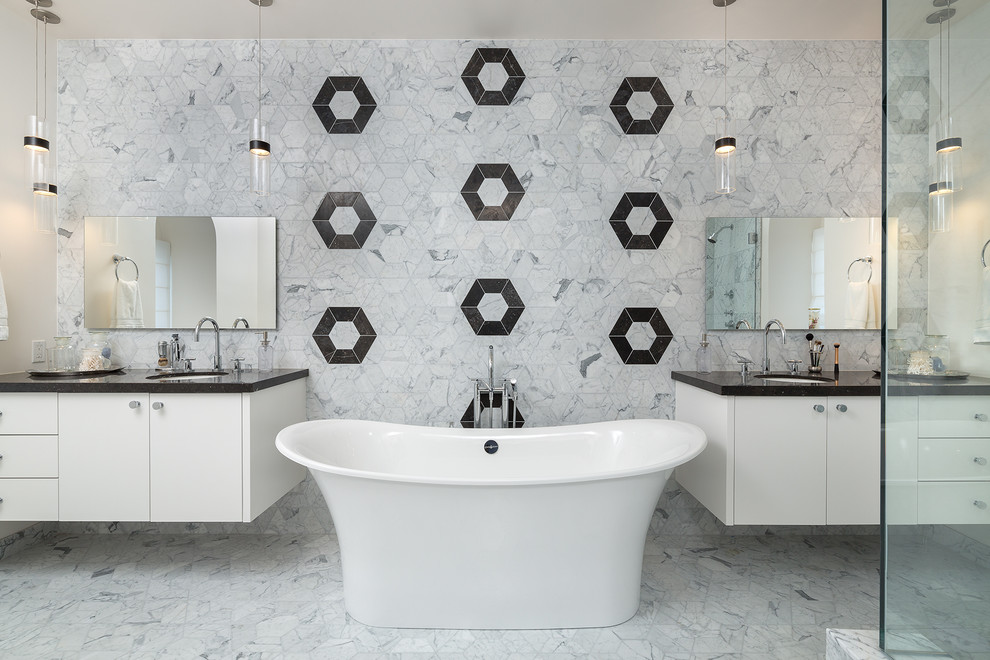 Photo of a mid-sized contemporary master bathroom in Los Angeles with recessed-panel cabinets, white cabinets, gray tile, quartzite benchtops, a freestanding tub, marble, grey walls, marble floors, an undermount sink and grey floor.