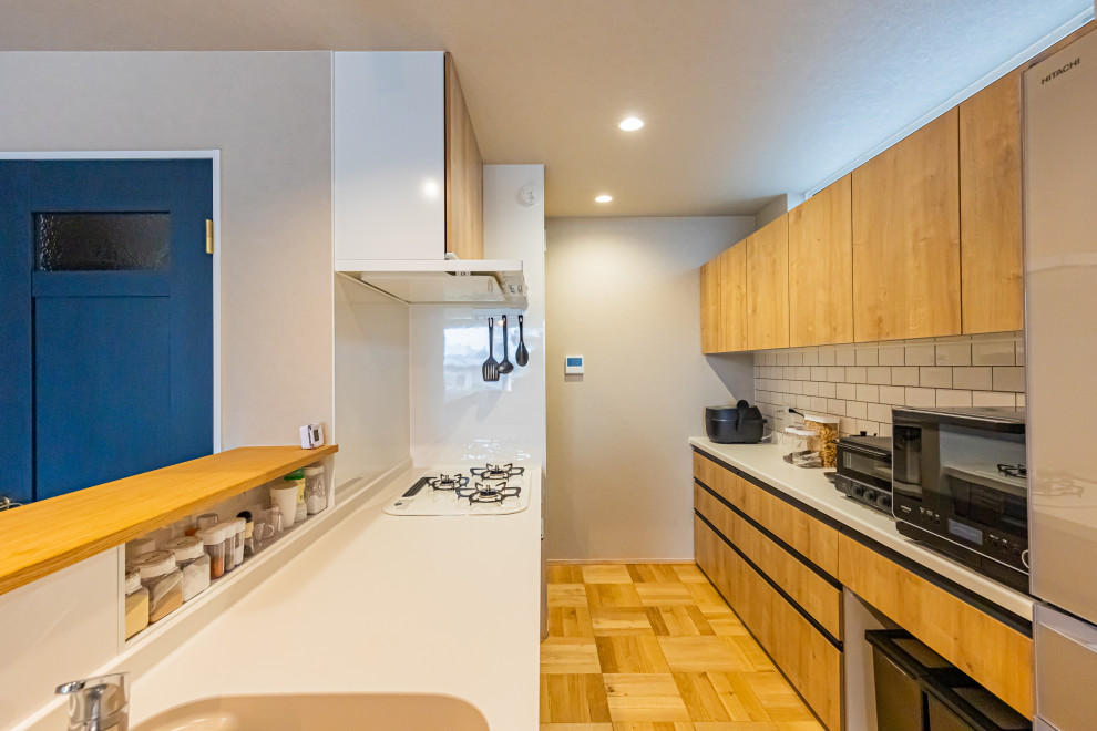 Immagine di una cucina minimalista di medie dimensioni con pavimento marrone e soffitto in carta da parati