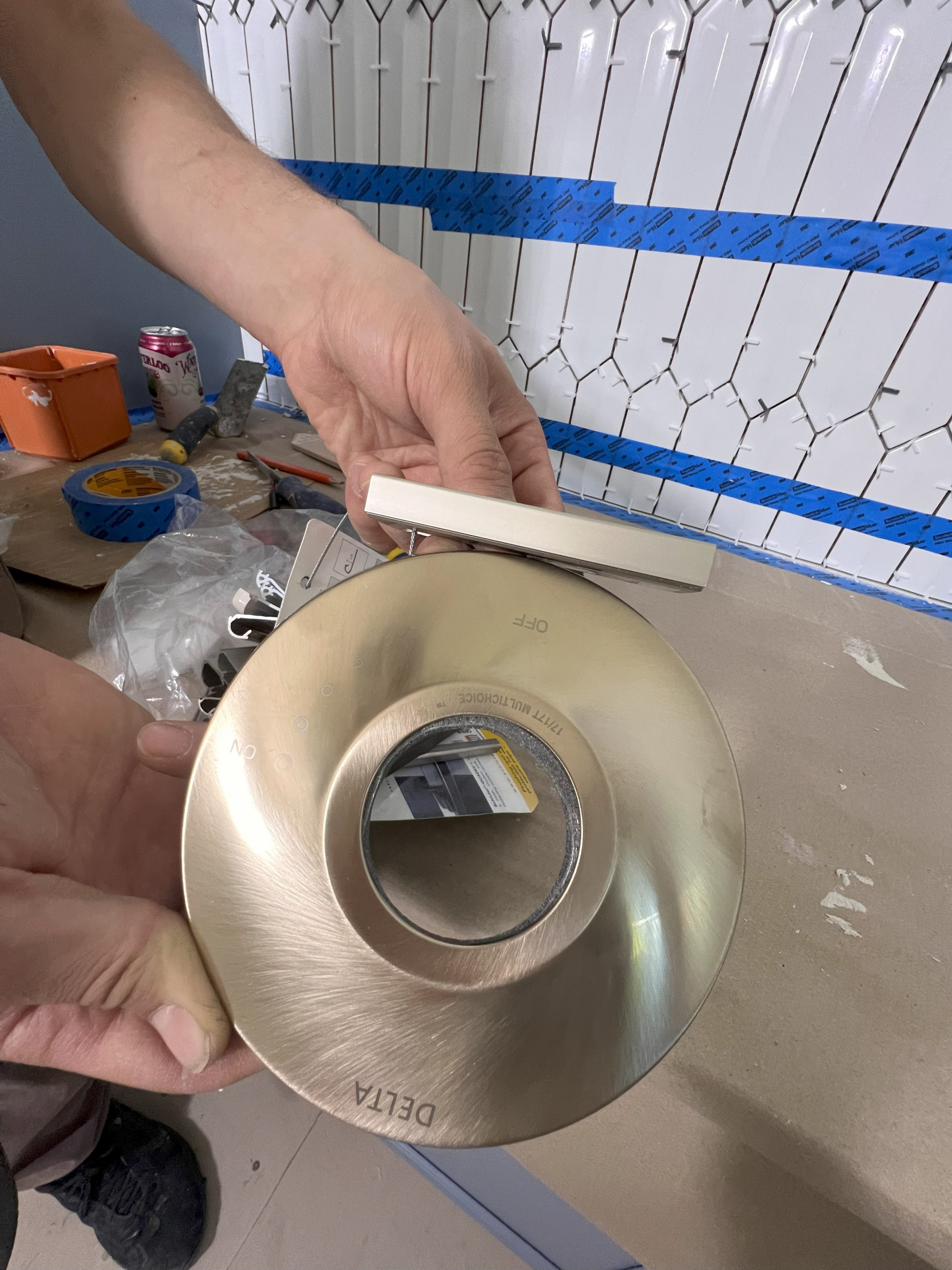 DURING! Matching the tile trim to the plumbing fixtures