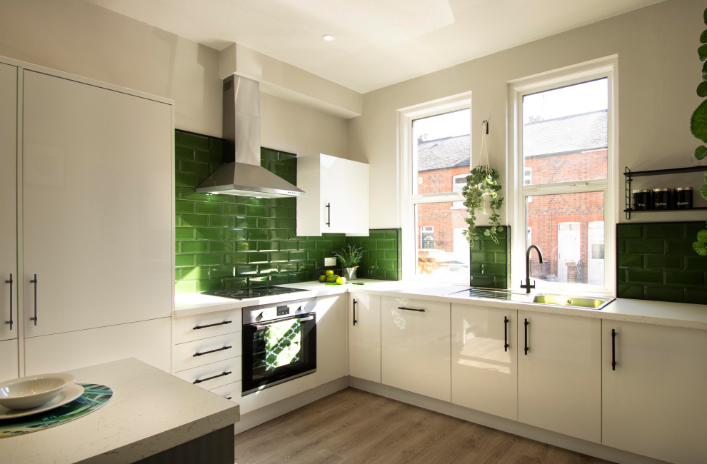 This is an example of a contemporary kitchen in Berkshire with with island.