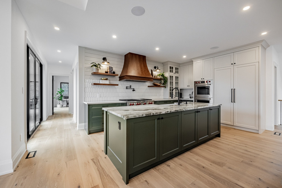 Inspiration for a small transitional u-shaped kitchen pantry in DC Metro with a single-bowl sink, green cabinets, quartz benchtops, white splashback, ceramic splashback, stainless steel appliances, bamboo floors, with island, brown floor and white benchtop.