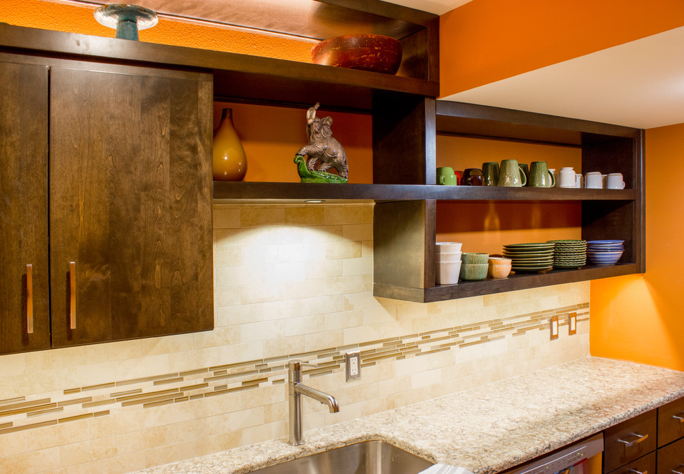 Inspiration for a small modern single-wall enclosed kitchen remodel in Cedar Rapids with an undermount sink, flat-panel cabinets, dark wood cabinets, beige backsplash, stainless steel appliances, granite countertops, subway tile backsplash and gray countertops