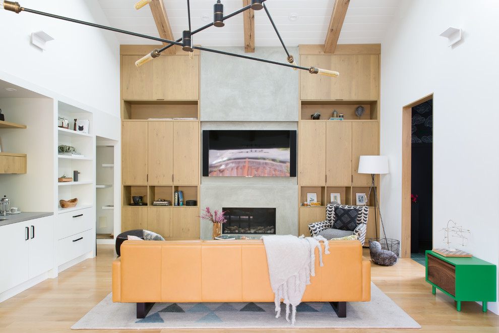 Midcentury open concept family room in San Francisco with white walls, light hardwood floors, a ribbon fireplace, a concrete fireplace surround, a wall-mounted tv and beige floor.