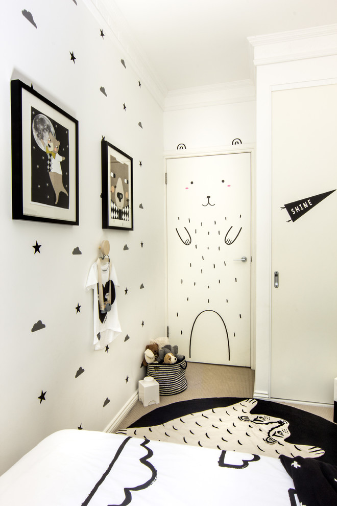 Design ideas for a small modern kids' bedroom for kids 4-10 years old and boys in Sydney with white walls and carpet.
