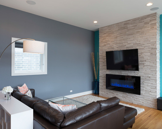 Photo of a large contemporary open concept living room in Chicago with blue walls, medium hardwood floors, a ribbon fireplace, a stone fireplace surround and a wall-mounted tv.