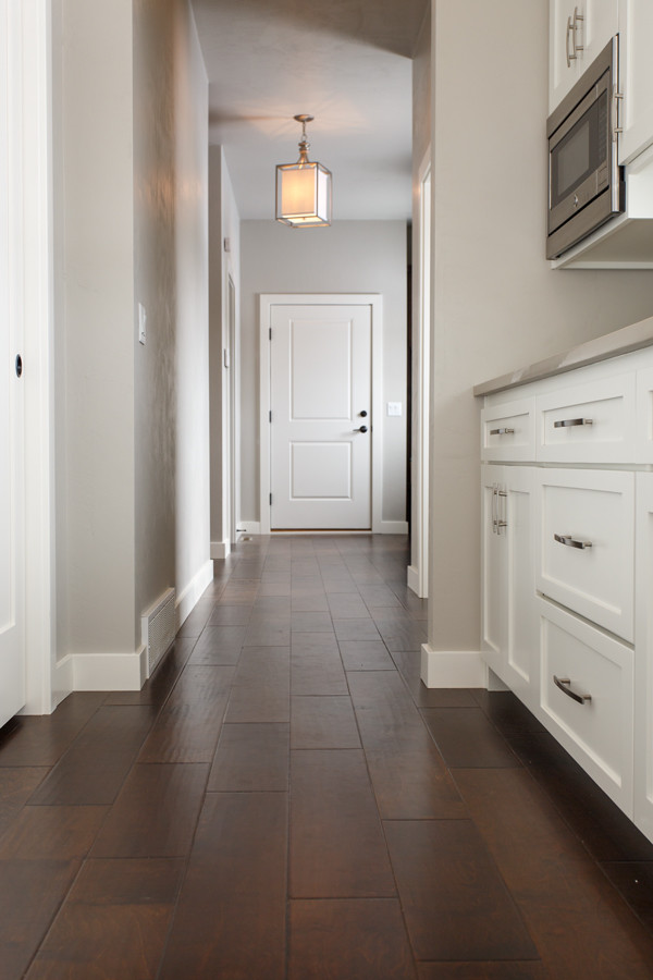 Inspiration for a mid-sized transitional medium tone wood floor and brown floor hallway remodel with beige walls