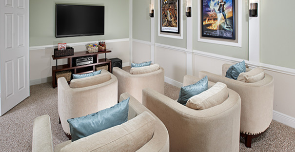 Design ideas for a mid-sized transitional enclosed home theatre in Orlando with green walls, carpet and a wall-mounted tv.