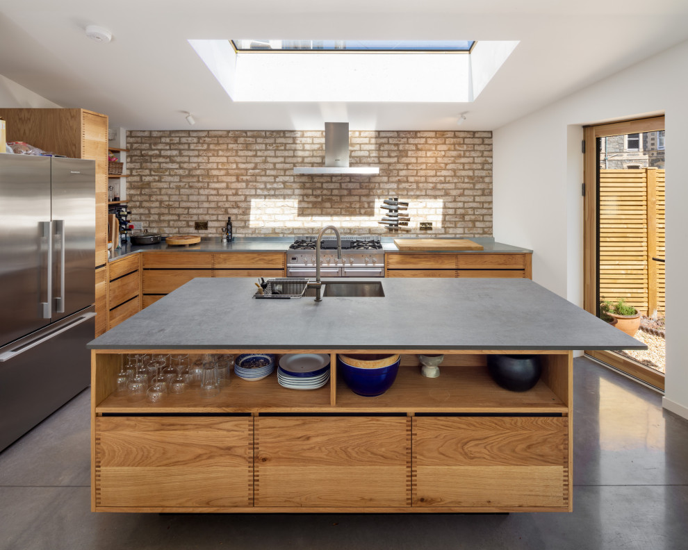 Design ideas for a mid-sized contemporary eat-in kitchen in Other with zinc benchtops, metallic splashback, panelled appliances, with island and grey benchtop.