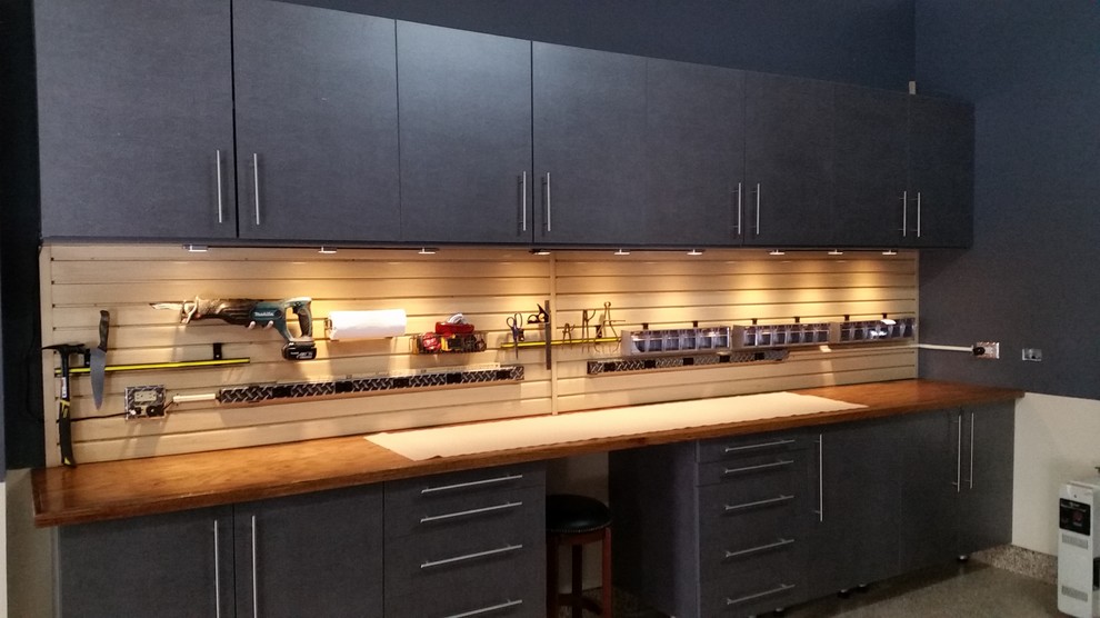 Mid-sized trendy attached two-car garage workshop photo in Chicago