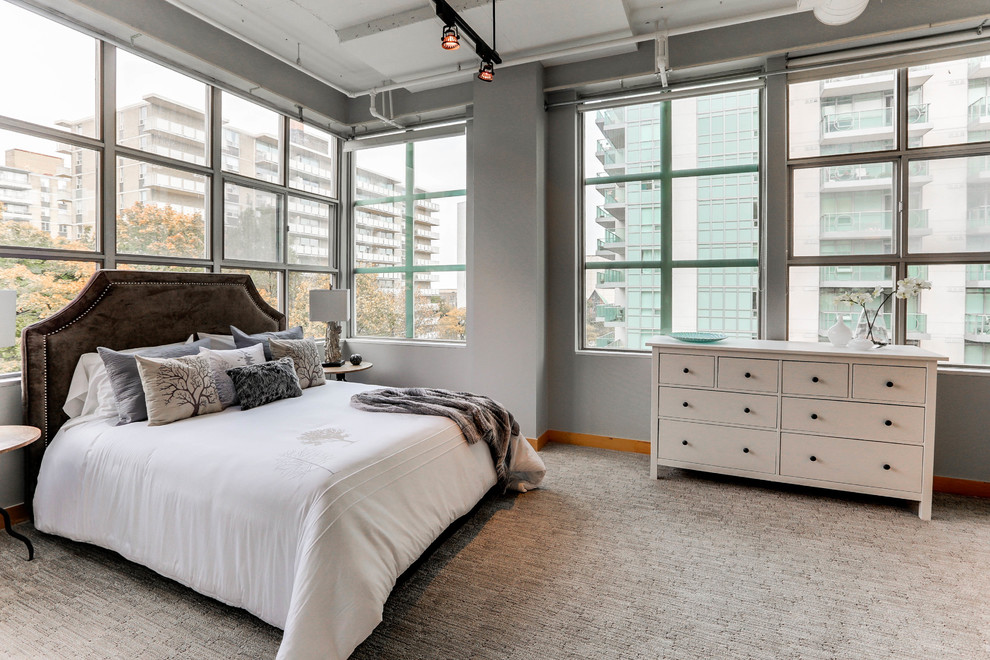 Large contemporary master bedroom in Toronto with grey walls, carpet, no fireplace and grey floor.