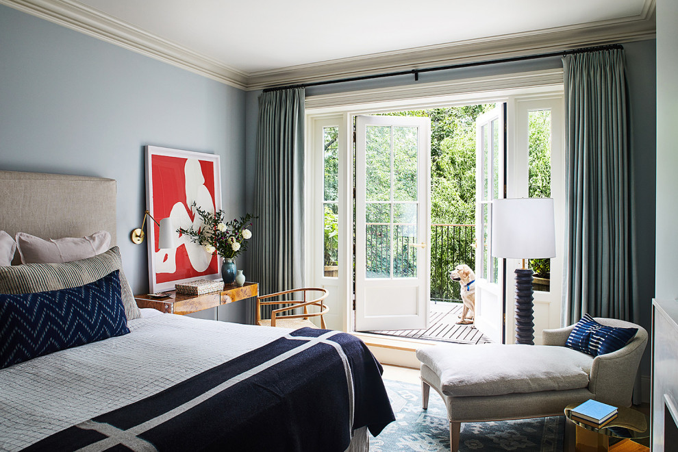 Inspiration for a transitional master bedroom in New York with blue walls and a standard fireplace.