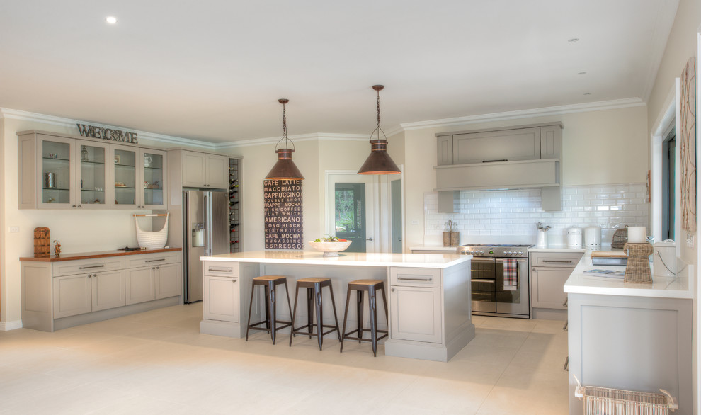 Inspiration for a large country eat-in kitchen in Sydney with shaker cabinets, quartz benchtops, white splashback, ceramic splashback, stainless steel appliances and with island.