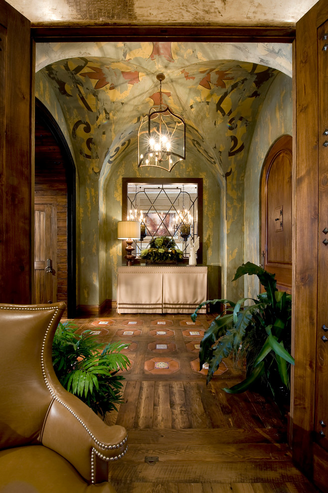 Inspiration for a mediterranean foyer in Orlando with green walls and dark hardwood floors.