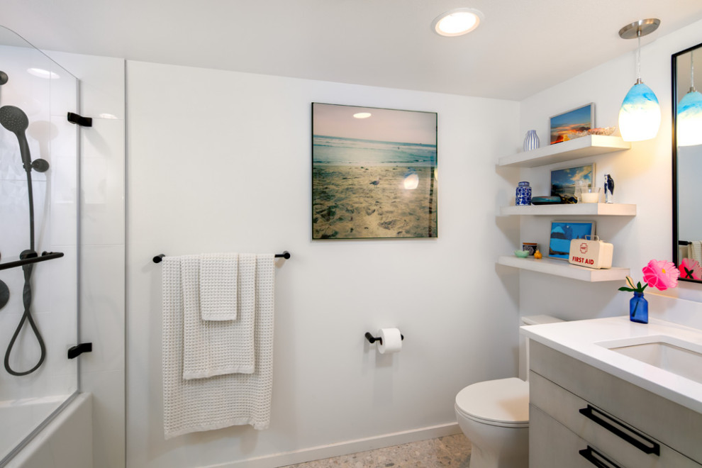 Photo of a small modern shower room bathroom in Seattle with flat-panel cabinets, white cabinets, an alcove bath, an alcove shower, a one-piece toilet, blue tiles, glass tiles, white walls, terrazzo flooring, a submerged sink, engineered stone worktops, grey floors, an open shower, white worktops, a single sink and a floating vanity unit.