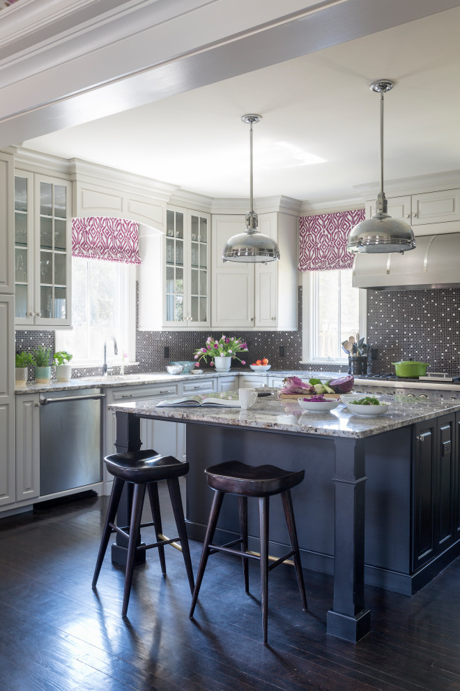 This is an example of a transitional l-shaped kitchen in Charleston with raised-panel cabinets, grey cabinets, black splashback, mosaic tile splashback, stainless steel appliances, dark hardwood floors, with island, black floor and grey benchtop.